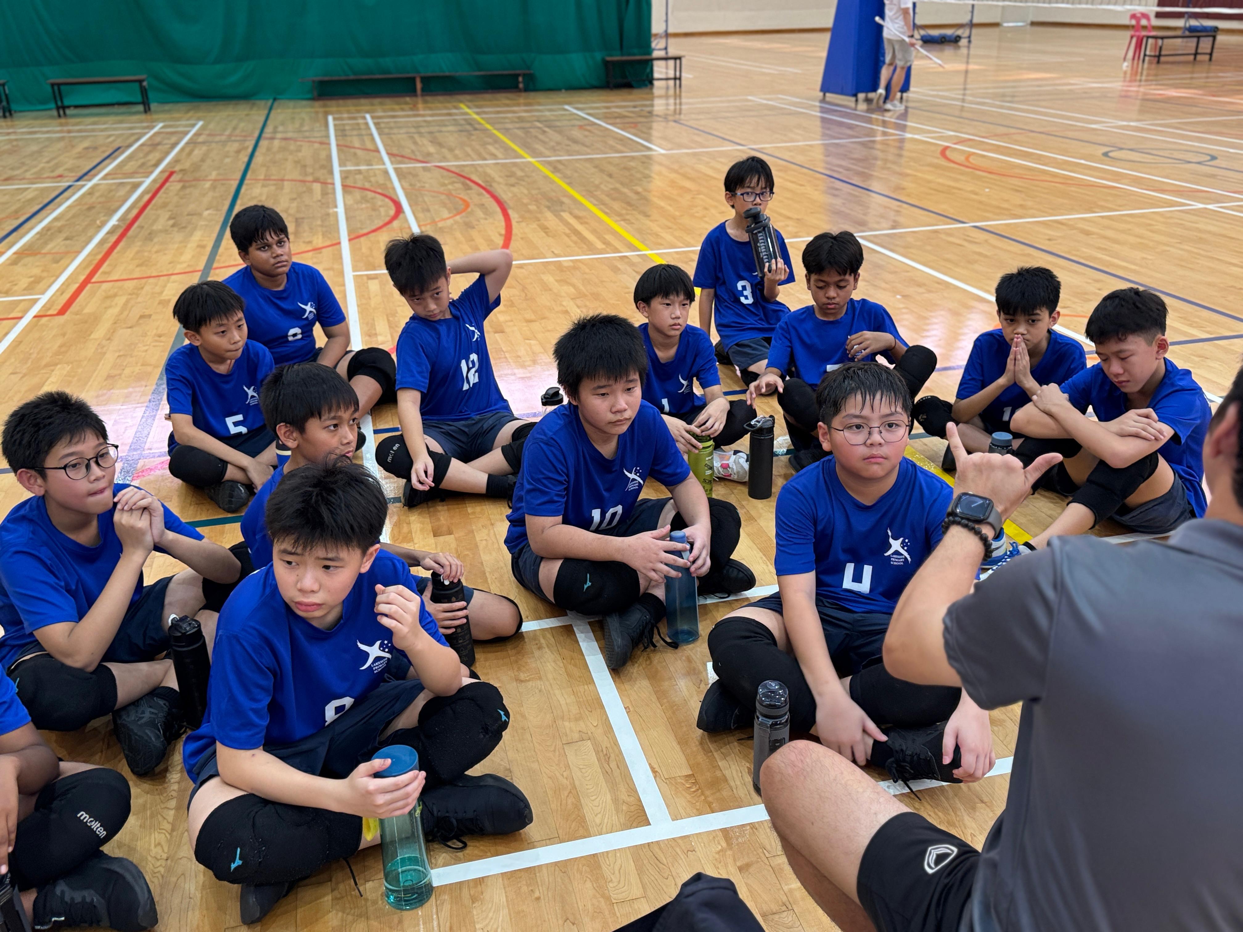 Students gathered around for a post-match debrief after a hard-fought competition.